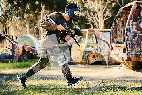 Image of Paintball player or man running with gun, outdoor competition or games in forest adventure or military training. Army skill, fitness or sports person in shooting battlefield, action or target mission