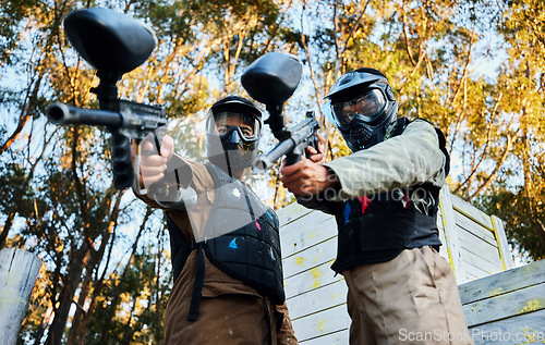 Image of Paintball, sports teamwork and men with gun for game, battle or competition. Collaboration, portrait or cooperation of people or friends on shooting range ready for target, aim practice and training