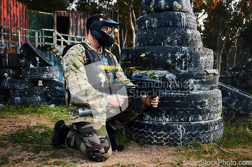 Image of Paintball, gun and camouflage with a sports man on a battlefield for military or war training for the army. Fitness, team building and safety with a male athlete or soldier playing a game outdoor