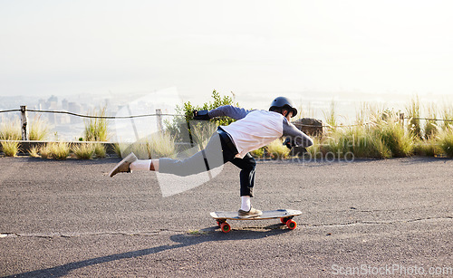 Image of Skateboard, moving and man in road for sports competition, training and exercise in urban city. Skating, skateboarding and male skater in action for speed, adventure and freedom for extreme sport