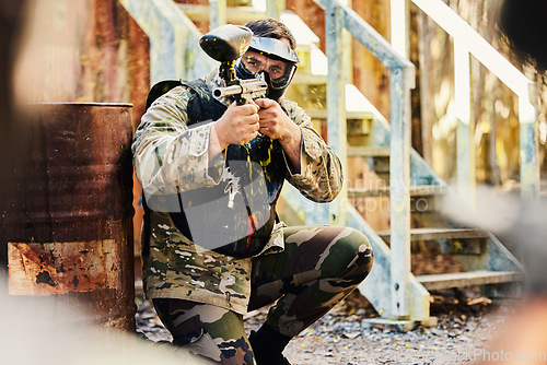 Image of Paintball, target training or male soldier with gun in shooting game playing with on fun battlefield mission. Aim or focused man with army weapons gear for survival in outdoor challenge competition