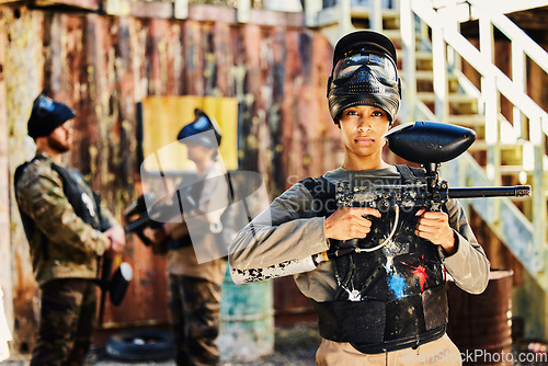 Image of Portrait, paintball or woman with gun in game or competition for fitness, exercise or cardio workout. Focus, challenge or serious girl carrying an army weapon or marker for military target training