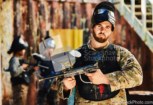 Image of Paintball, serious or portrait of man with gun in shooting game playing in action battlefield mission. War, hero or focused soldier with army weapons gear in survival military challenge competition