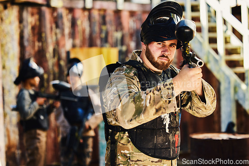 Image of Paintball, target or portrait of man with gun in shooting game playing in action battlefield mission. War, hero or focused soldier with army weapons gear in survival military challenge competition