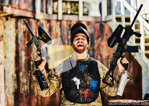 Image of Paintball, laughing or portrait of happy man with guns in shooting game playing or celebrates battlefield mission. Crazy or funny soldier with army weapons gear winning military challenge competition