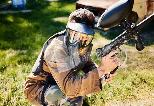 Image of Paintball, target practice or male with gun in shooting game playing with on war battlefield mission. Army training or focused soldier with weapons gear in survival military challenge competition