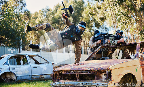 Image of Car, jump or man in paintball shooting game playing with speed or fast action on fun battlefield. Mission focused, military or player running with guns gear for survival in an outdoor competition