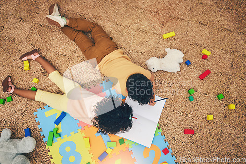 Image of Drawing, book and top view of children on floor with toys, number puzzle and playing together at home. Family, educational games and happy boy and girl do fun activity, creative learning and relax