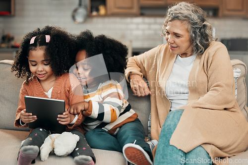 Image of Watching, movie and children with grandmother and a tablet for games, education or website. Interracial, digital and girls playing on technology, streaming a show and film with a senior woman