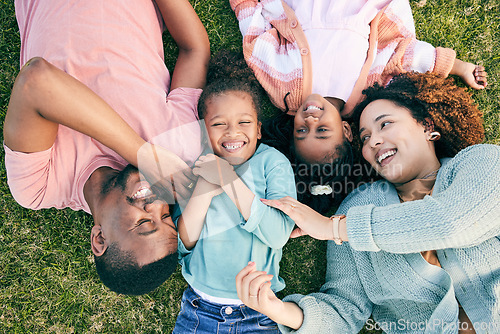 Image of Top view, happiness and black family on grass, quality time and carefree in park, break and smile. Mother, father and children in backyard, cheerful and playful together for bonding, loving and relax