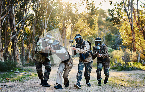 Image of Battlefield, military and people with guns for paintball, shooting game and training in nature. Army, teamwork and group of friends playing games, running for battle and target adventure in forest