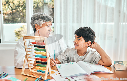 Image of Grandma help, child abacus learning and home studying in a family house with education and knowledge. Senior woman, boy and teaching of a elderly person with a kid doing writing for a class project