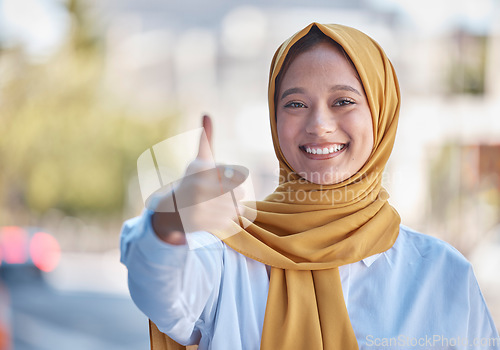 Image of Thumbs up, smile and portrait of Muslim woman in city for achievement, relax and natural in Indonesia. Islamic, positive and confident with girl wearing hijab in urban town for yes, agreement and joy