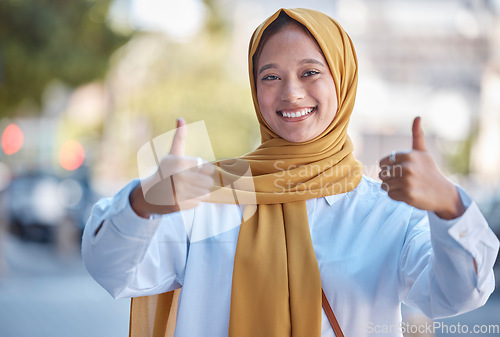 Image of Thumbs up, happy and portrait of Muslim woman in city for achievement, like and natural in Indonesia. Islamic, positive and confident with girl wearing hijab in urban town for yes, agreement and joy