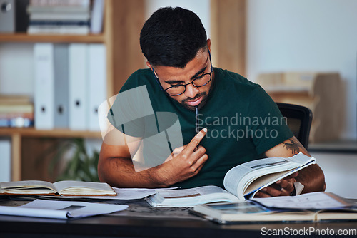 Image of Student, black man and books to study on home desk thinking, reading and studying for college. Person learning and focused on information on page for education, knowledge and working on law research