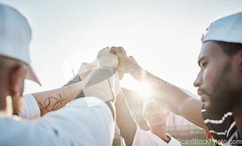 Image of Fist, motivation or sports people in huddle with support, hope or faith on baseball field in game. Teamwork, group partnership or softball athletes with hands together for solidarity or inspiration