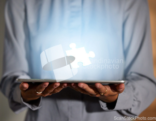 Image of Hands, tablet and 3D hologram of puzzle piece for planning, strategy or problem solving in technology at night. Hand of business person holding futuristic touchscreen and holographic jigsaw at office