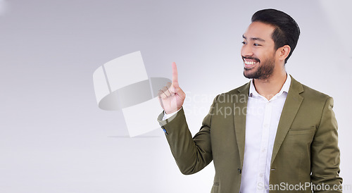 Image of Mock up, finger and businessman pointing up for branding, product placement and advertising isolated in a studio white background. Latino, professional and man corporate worker is happy for deal