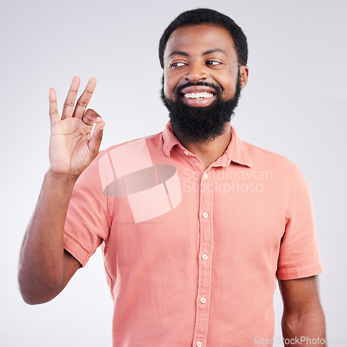 Image of Perfect, happy and okay sign with black man in studio for deal, success and good news. Thank you, agreement and emoji with male isolated on gray background for celebration, opinion and confidence