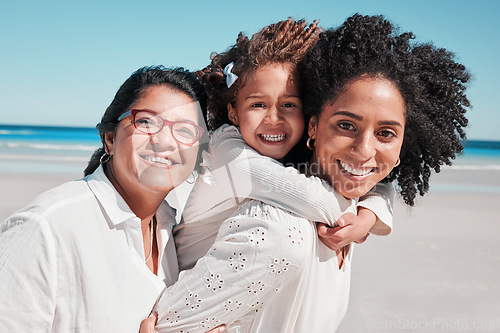 Image of Portrait, mother and grandmother with girl at beach, smiling and bonding together at seashore. Care, family and happy grandma and mama carrying kid, having fun and enjoying summer time vacation.