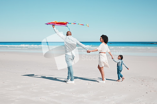 Image of Holding hands, kite and family walking together at a beach, relax and bonding on ocean background. Flying, toy and couple with daughter at the sea, walk and enjoy a trip in Miami with fun games