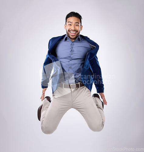 Image of Jump, excited and portrait of man in studio with surprise, happiness and celebration on white background. Winner, success mockup and isolated happy male jumping with energy for winning, smile and joy