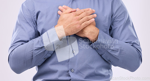 Image of Closeup, hands on chest and man in studio with self love, hope and love on grey background space. Zoom, hand and open heart gesture by male show emoji, gratitude and calm zen while standing isolated