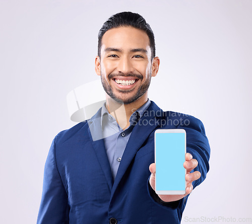 Image of Portrait, mockup and Asian man with smartphone, green screen and happiness against grey studio background. Face, Japanese male ceo and employee with cellphone, space and social media with connection