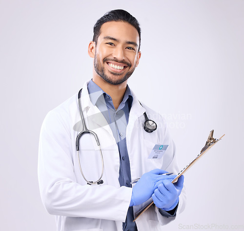 Image of Portrait, doctor and man with clipboard, healthcare and happiness against grey studio background. Face, male employee and happy medical professional with document, paperwork and report for diagnosis