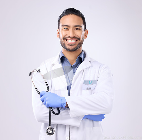 Image of Portrait, Asian man and doctor with stethoscope, success and motivation against grey studio background. Face, employee and medical professional with happiness, healthcare and consultant with wellness