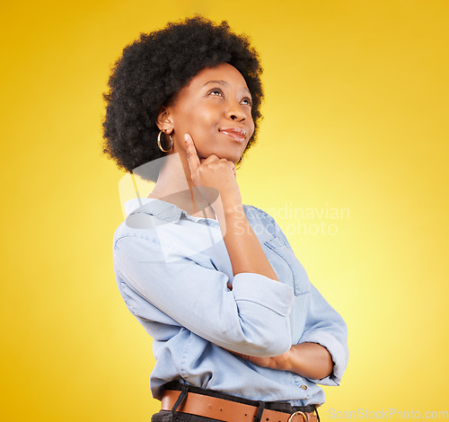 Image of Black woman, thinking face and smile in studio with idea or memory on yellow background. African female think of space with afro hair, beauty and happiness for motivation and mindset for planning