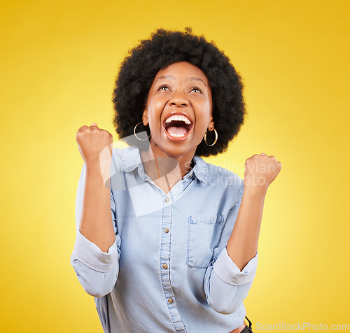 Image of Black woman, excited face and celebrate win in studio while happy on yellow background. African female model with hands or fist for victory, promotion or bonus lottery prize achievement or surprise