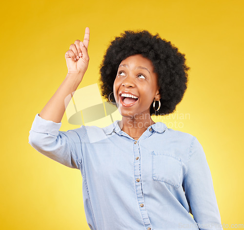 Image of Studio promotion, happy and black woman point at mock up space, advertising mockup or marketing promo. Commercial girl, gesture and excited person with product placement deal on yellow background