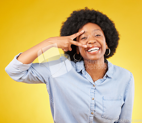 Image of Black woman, peace sign and smile portrait in studio while happy on yellow background. African female model with hand gesture or emoji while laughing on color with motivation and positive mindset
