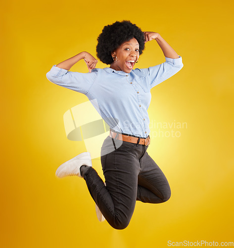 Image of Jump, muscle flex and portrait of black woman on yellow background with energy, happiness and smile in studio. Success mockup, celebration and isolated happy girl jumping for freedom, winning and joy
