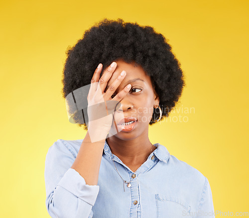 Image of Frustrated, stress and angry with black woman in studio for tired, exhausted and mental health. Failure, bored and scared with female isolated on yellow background for difficulty, trouble and fear