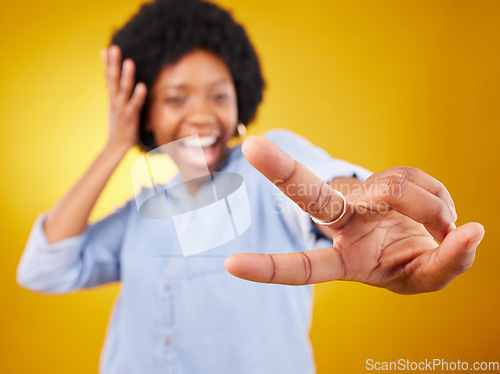 Image of Happy, peace sign and hand of a black woman in studio with a positive and goofy mindset. African female model posing with finger gesture while happy about motivation or victory on yellow background