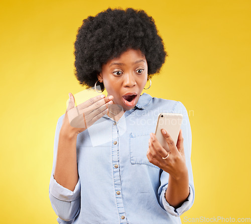 Image of Phone, surprise and shock of black woman in studio isolated on a yellow background. Wow, cellphone and surprised African female with smartphone for reading fake news on social media, omg or wtf emoji