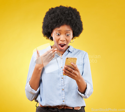 Image of Phone, surprise and wow of black woman in studio isolated on a yellow background. Shock, cellphone and surprised female with smartphone for good news on social media, winning lottery or competition.