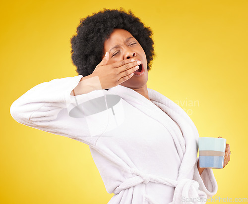 Image of Yawning, coffee and tired black woman in studio, waking up and sleepy on yellow background space. Exhausted, yawn and female with tea in bathrobe, emoji and fatigue gesture while posing isolated