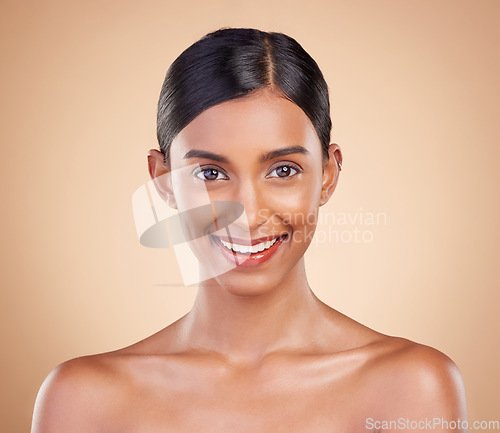 Image of Portrait, beauty and smile with a model woman in studio on a beige background for natural skincare. Face, happy and aesthetic with an attractive young female posing for cosmetics or luxury wellness