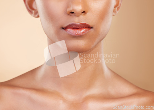 Image of Skincare, face and mouth of a woman with a glow isolated on a studio background. Beauty, makeup and a girl glowing from cosmetics, healthy skin and results from dermatology treatment on a backdrop