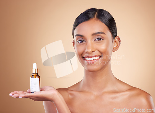 Image of Portrait, skincare and serum with a model woman in studio on a beige background to promote beauty. Face, product and antiaging with an attractive young female posing for cosmetics or luxury wellness