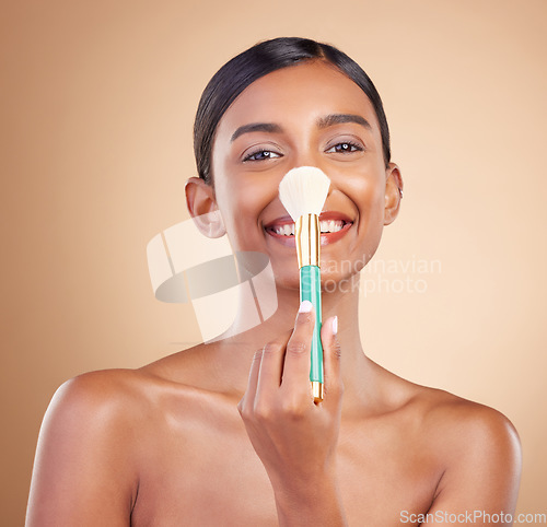 Image of Portrait, nose and blush with a model woman in studio on a beige background to promote makeup. Face, blusher and product with an attractive young female posing for cosmetics or luxury wellness