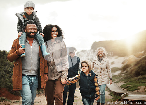 Image of Family hiking outdoor, together with nature and happiness, bonding and spending quality time with fitness and generations. Grandparents, parents and children walking, love and care with happy people