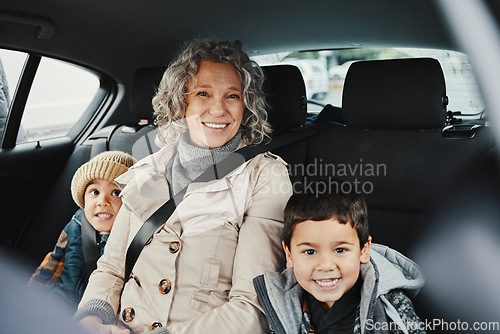 Image of Portrait, car ride and grandmother relax with children or grandchildren while travel or on a road trip in the backseat. Bonding, happy and grandma traveling with kids or grandkids on a journey