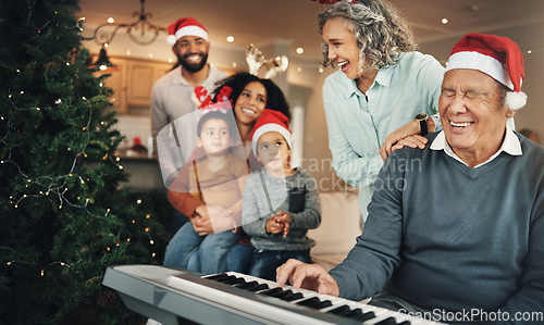 Image of Christmas, happy family and senior man on piano in living room for celebration, song and bond in their home. Music, instrument and retired pianist performing for kids and parents on festive holiday