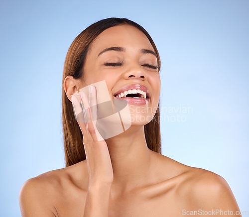 Image of Skincare, confident and woman beauty with clear and clean skin after a facial isolated in a studio blue background. Soft, natural and self care model due to dermatology due to cosmetic treatment