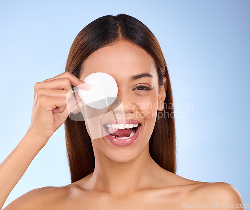 Image of Beauty, woman and face with cotton pad for skincare dermatology cosmetics in studio. Female model person on a blue background for self care, facial glow and healthy or detox skin with clean results