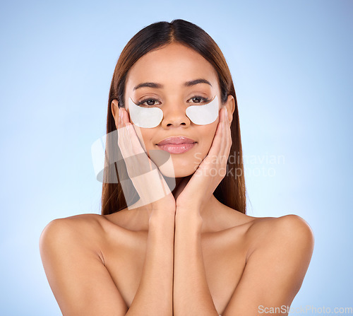 Image of Beauty, collagen and portrait of woman with eye mask for anti aging skincare glow on blue background. Cosmetics, facial repair and face of hispanic model with wrinkle treatment product in studio.